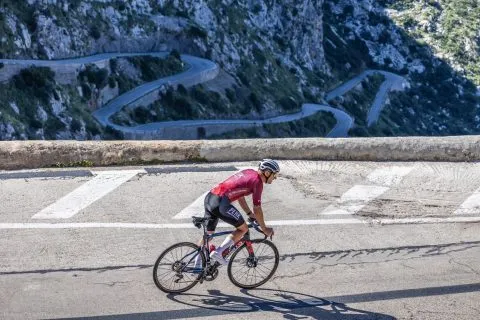Peak Sports Coaching rider on a mountain switchback road