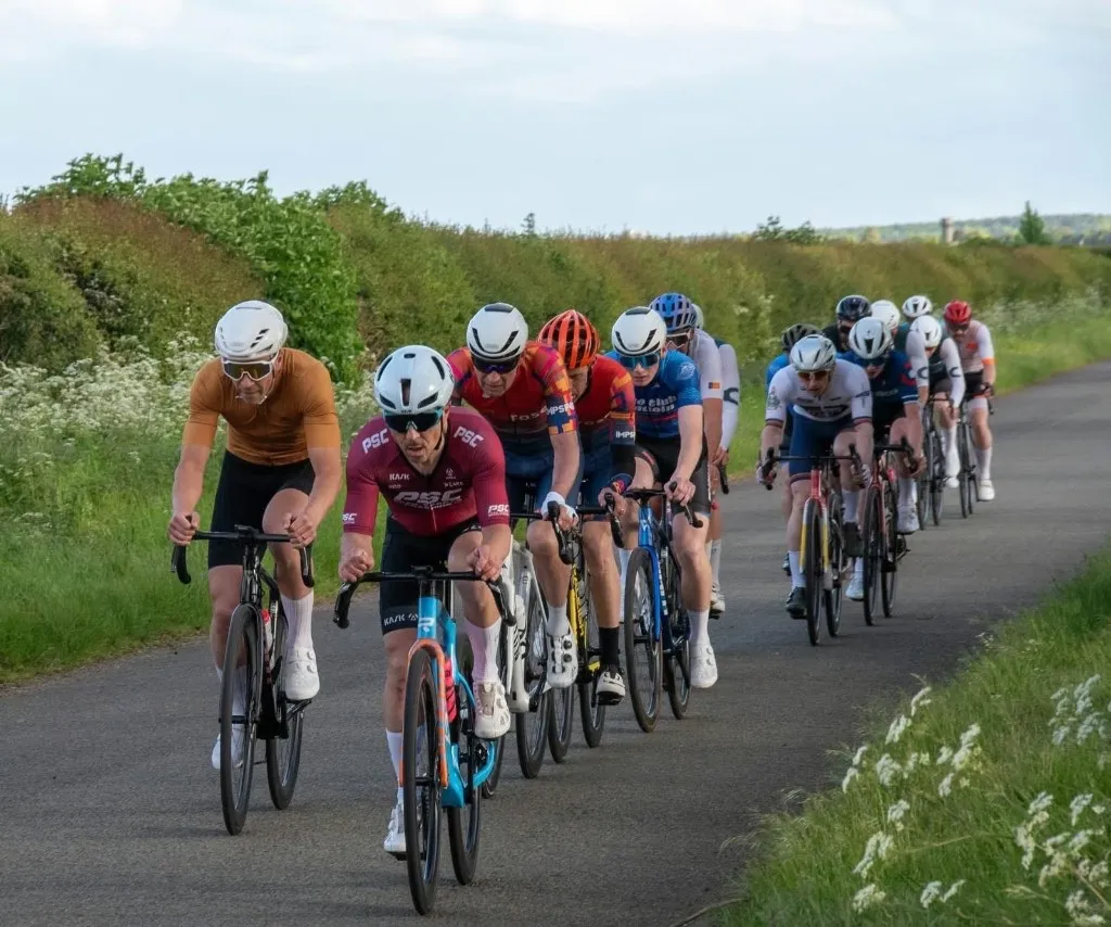Peak Sports Coaching rider in the bunch on a country road