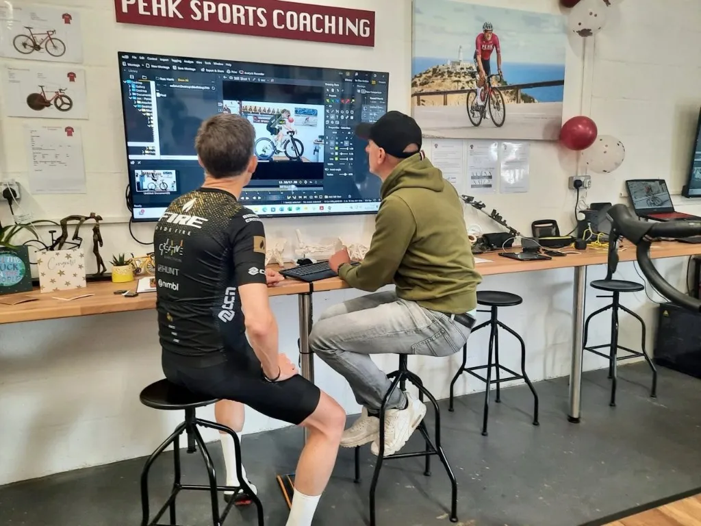 Kevin and Jon reviewing motion analysis data on screen at Peak Sports Coaching