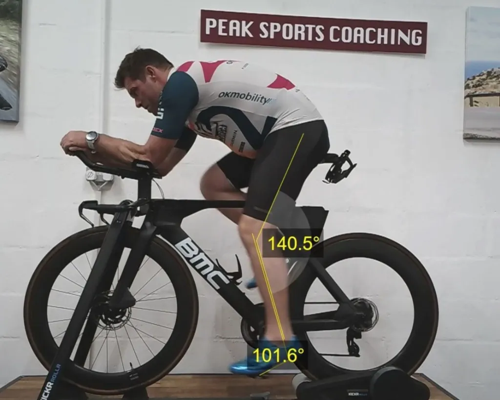 Matt Jansen on his BMC TT bike during motion analysis at Peak Sports Coaching, with knee and ankle angle overlays