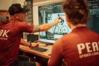 Fitter reviewing Velogicfit video analysis with a rider